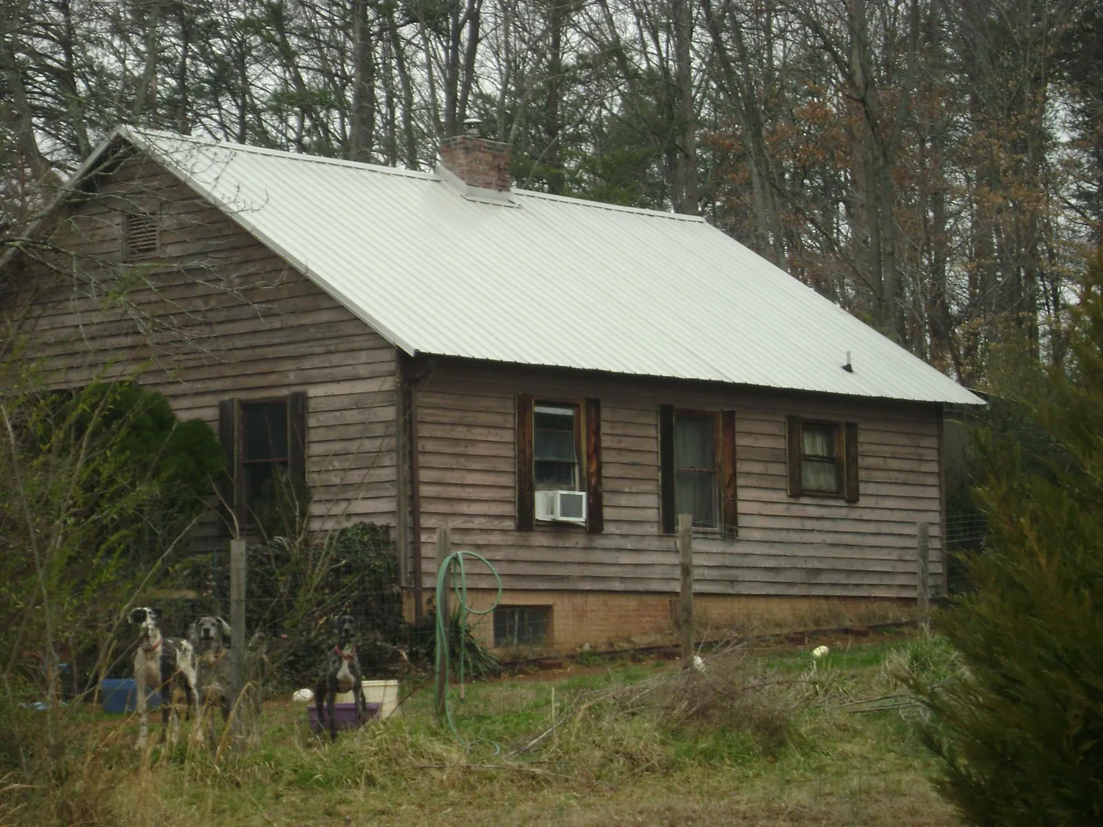 White metal roof on an old wood sided farmhouse, from a Metal Roof Installation job in Pekin